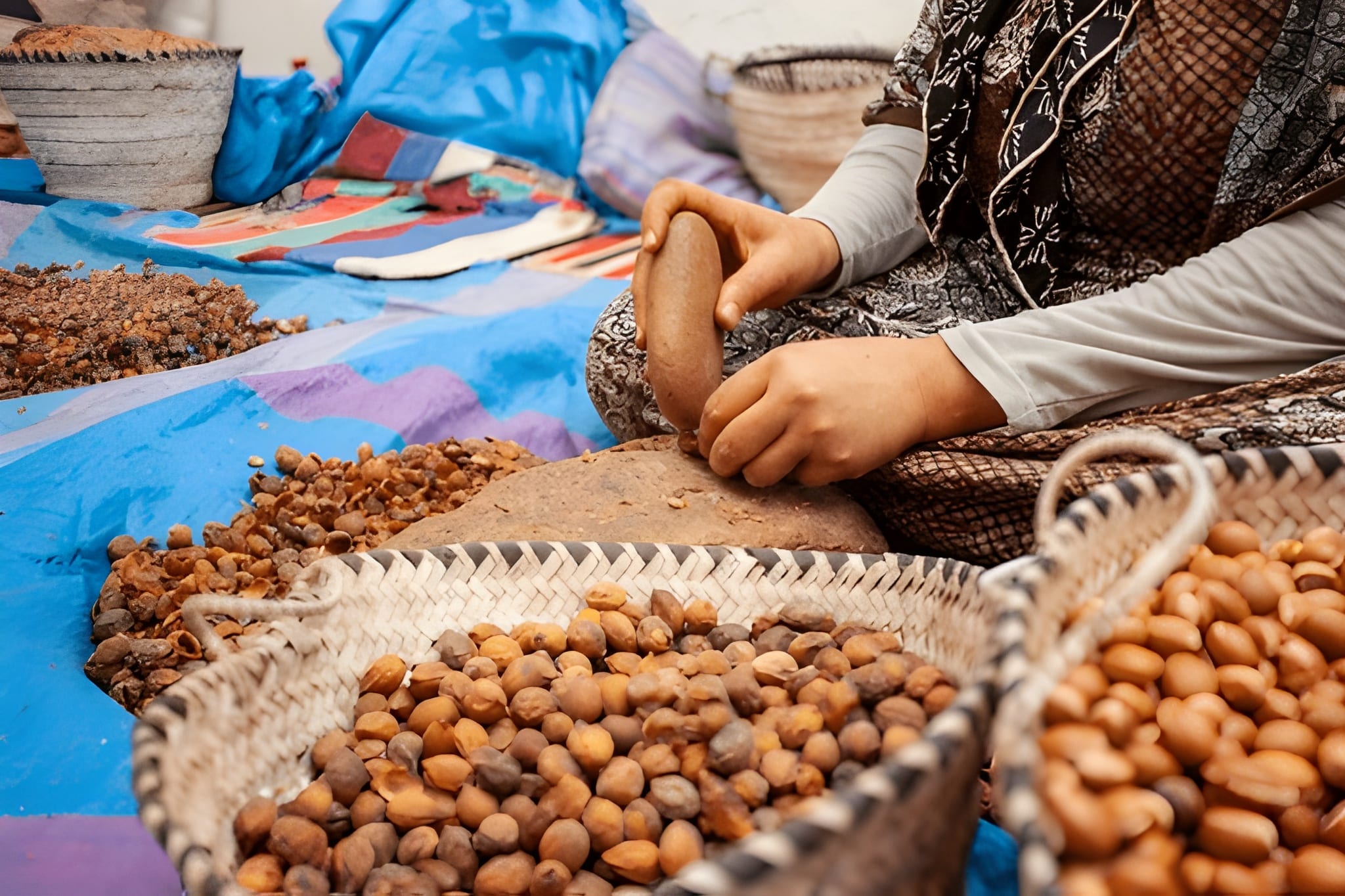 Traditional Argan oil production at women's cooperative Agadir Morocco grinding nuts by hand